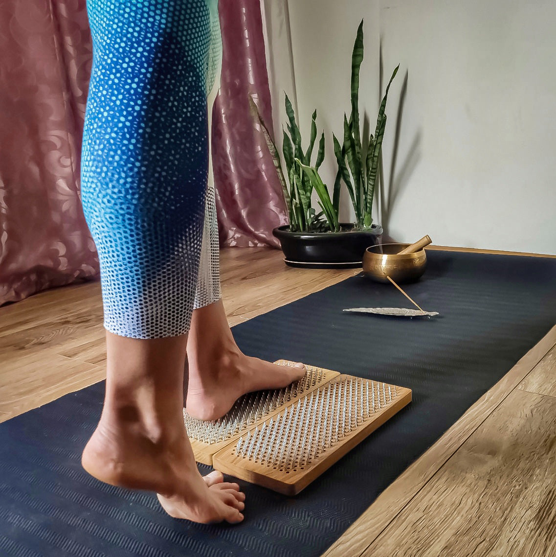 Women's feet stands on Sadhu Board
