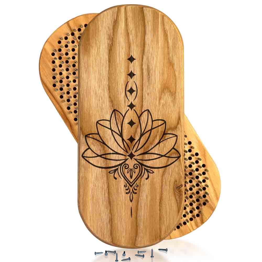 Wooden sadhu nail board with lotus design for yoga on a white background