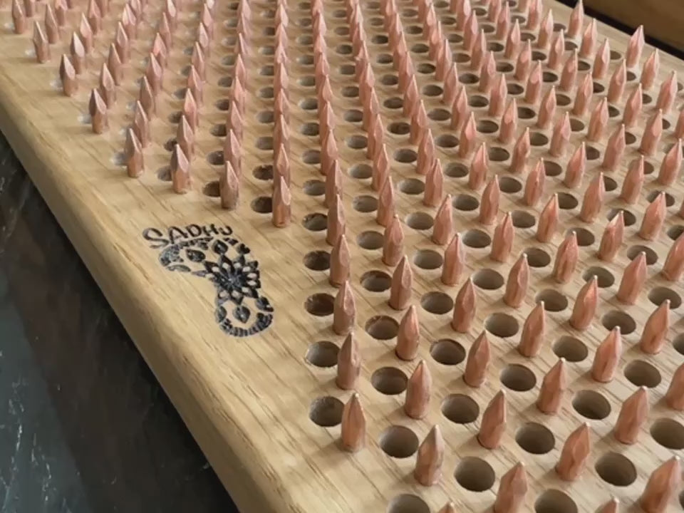sadhu board copper nails from natural oak wood in natural color showed in details with engraving logo oh! on one sadhu board and sadhu on second one sadhu board.
