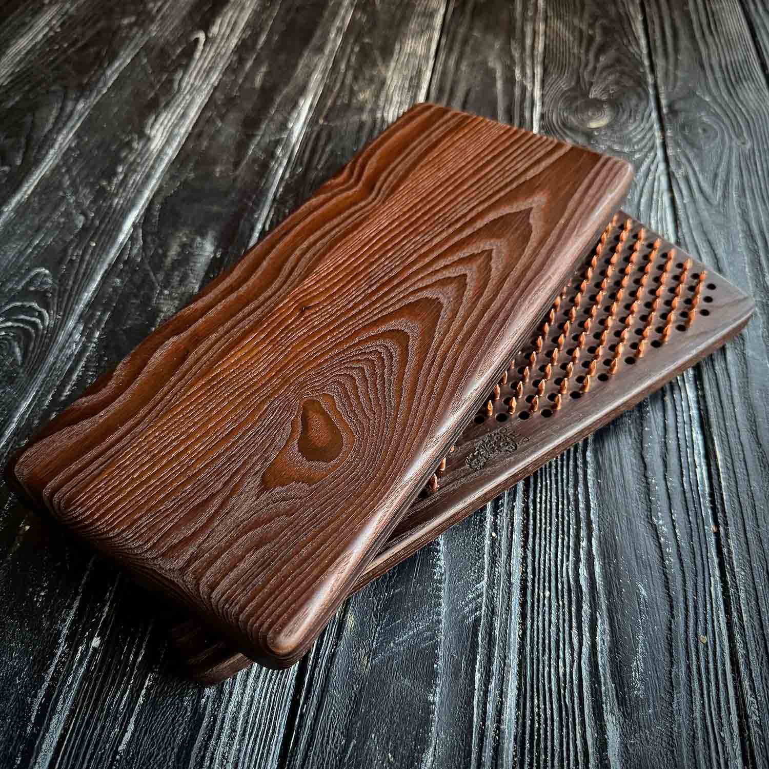 sadhu board with copper nails in natural brown color on black background