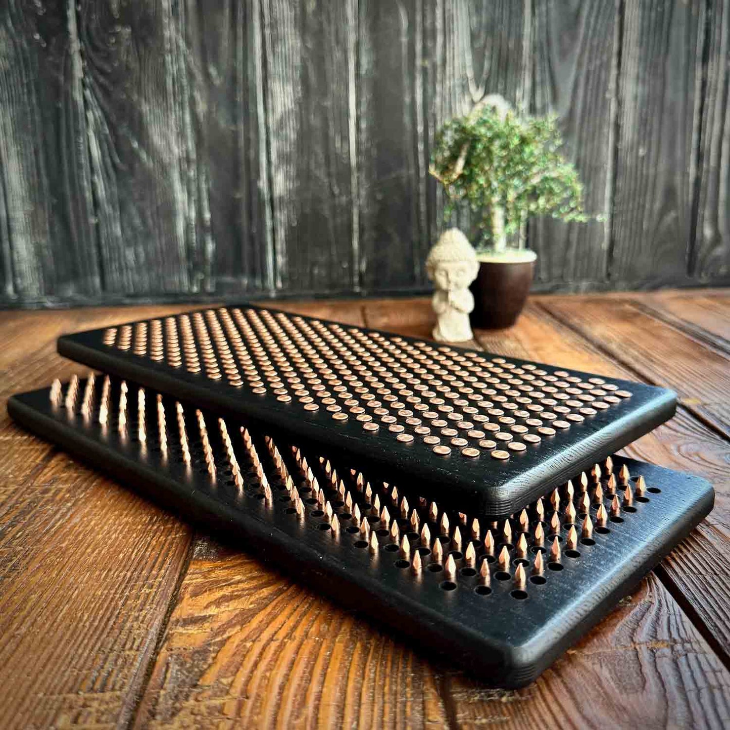 Black nail boards on a wooden surface with a wooden blurred background