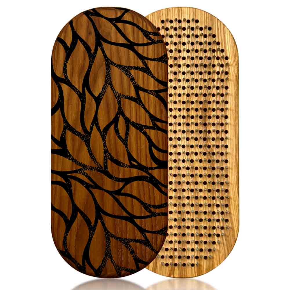 Two wooden sadhu boards with leaves patterns on a white background