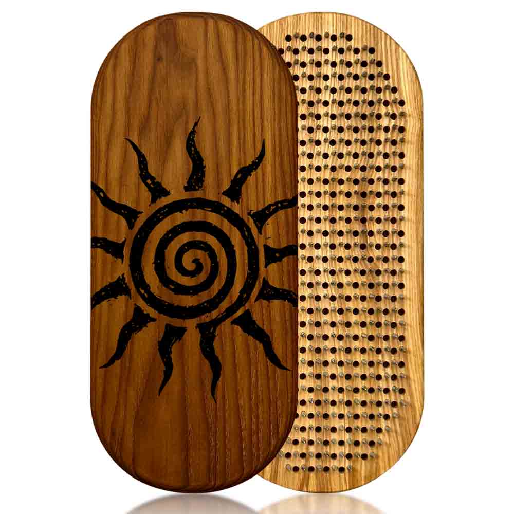 Wooden sadhu board with sun design on one side and nail pattern on the other, on a white background.