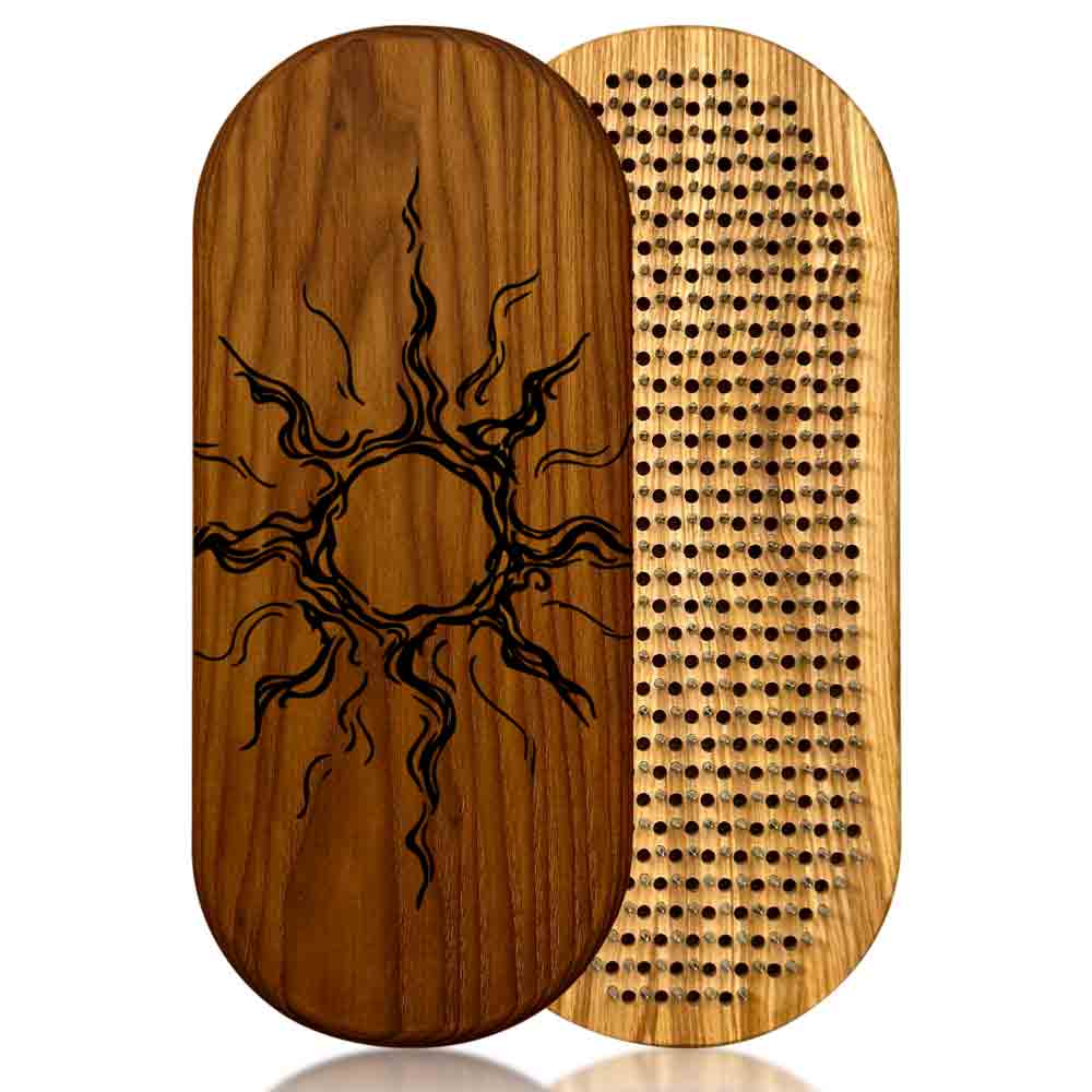 Wooden sadhu nail board with sun design on one side and nails side on the other, on a white background.