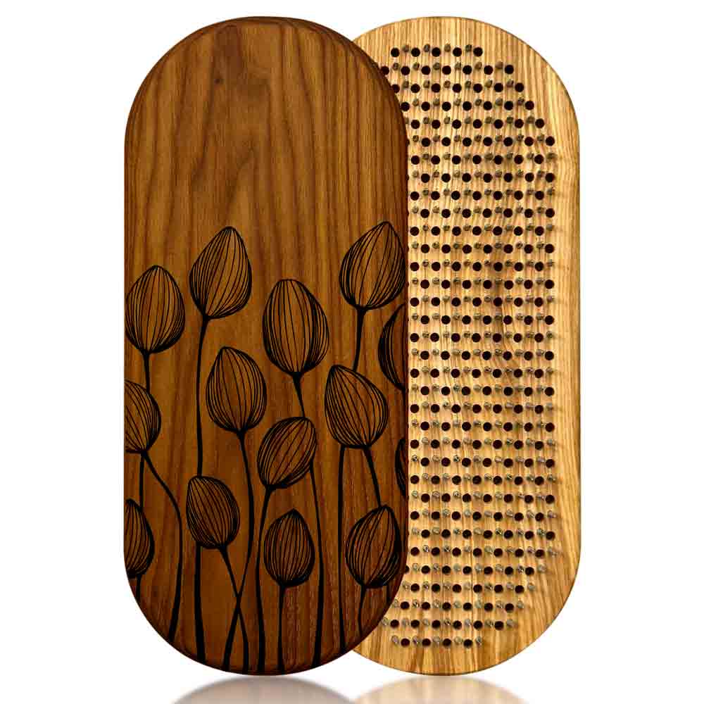 Two wooden sadhu boards, one with floral pattern and the other with nails, on a white background.