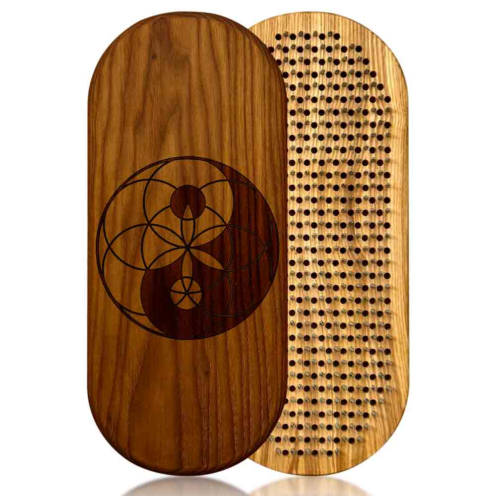 sadhu board from ash and thermo ash with yin yang and flower of life engraving on a white background.