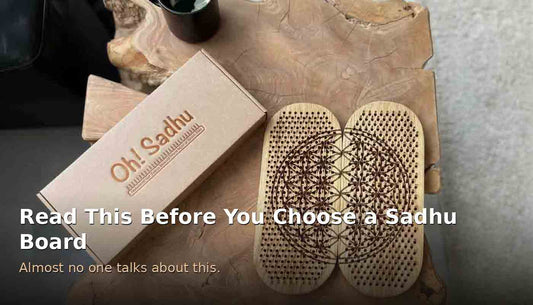 Oh! Sadhu box next to an oak sadhu board with copper nails engraved with a Flower of Life pattern, on a natural wood table.