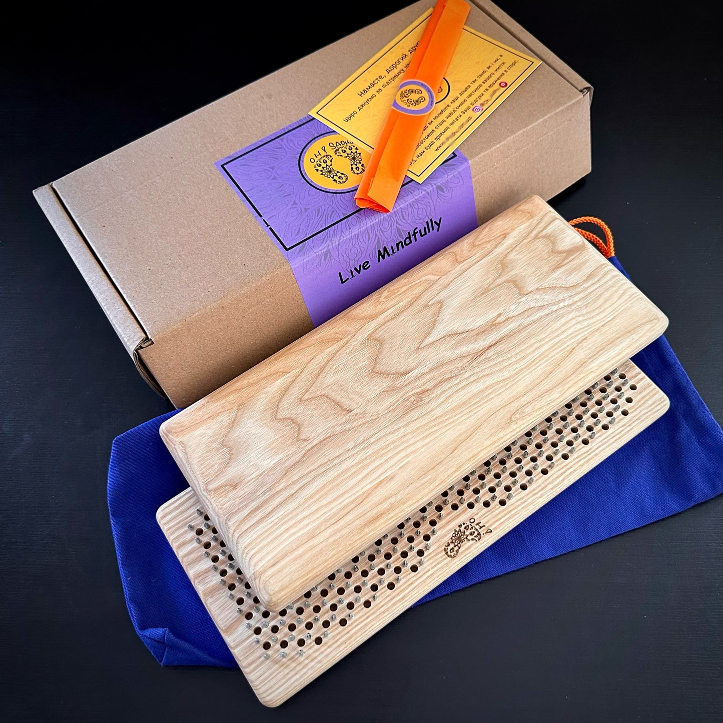 sadhu board set includes gift box, pouch, 2 sadhu boards, aroma stick, instruction on black background