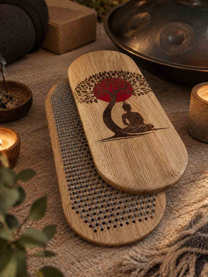 Sadhu board with engraved Buddha sitting under the Bodhi tree with red sun in yoga studio with handpan, candles and other yoga stuff. 