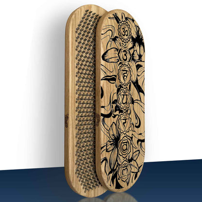 Half folded sadhu boards for beginners made from oak. Outer side with engraving of chakras with flowers and inner side with nails arranged in Flower of Life pattern with step 8mm. Boards in vertical position on blue-white background.