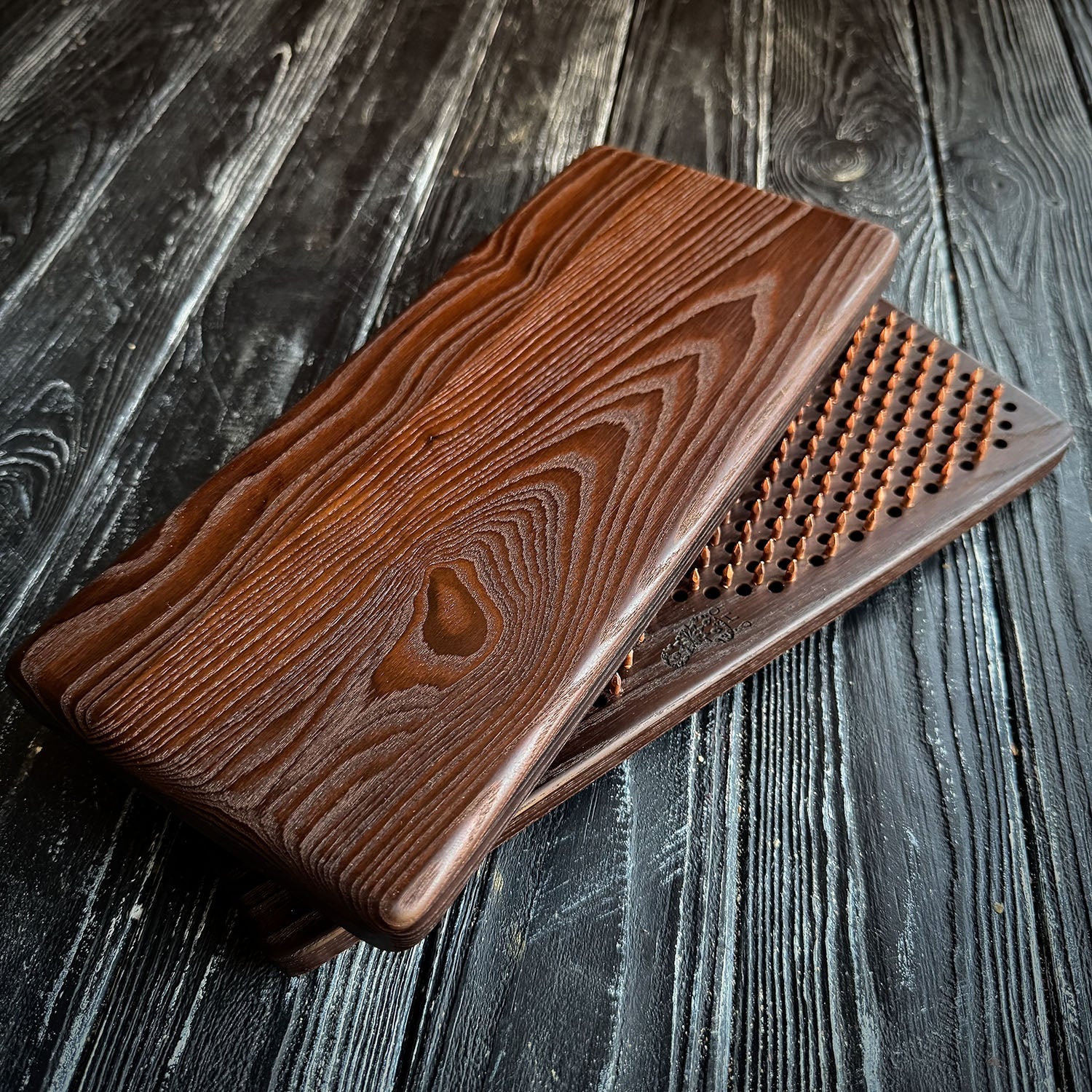 termo ash sadhu board with copper nails on black background