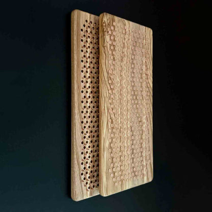 natural ash wood sadhu board with copper nails on black background