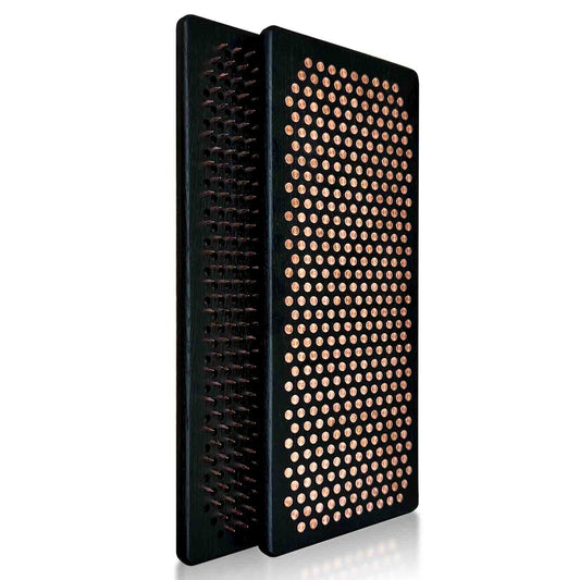 Black sadhu board with copper nails for feet on white background