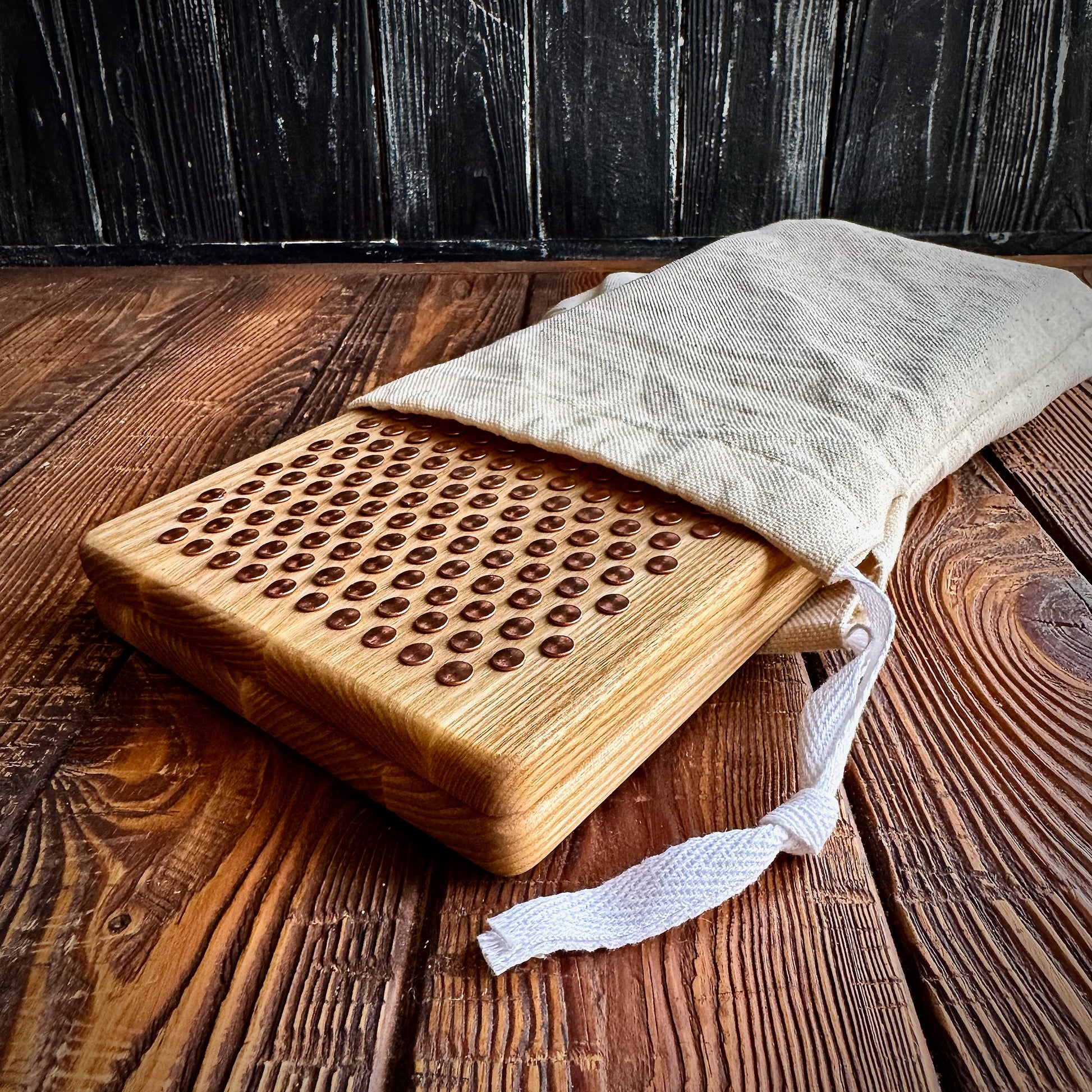 sadhu board with copper nails in white fabric case