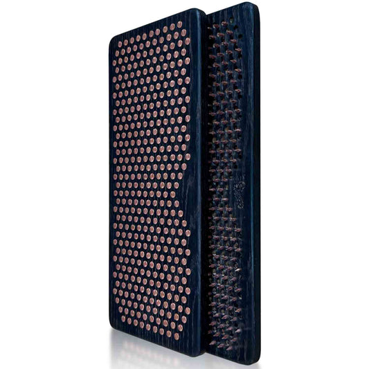 Two black Sadhu boards with copper nails on a white background