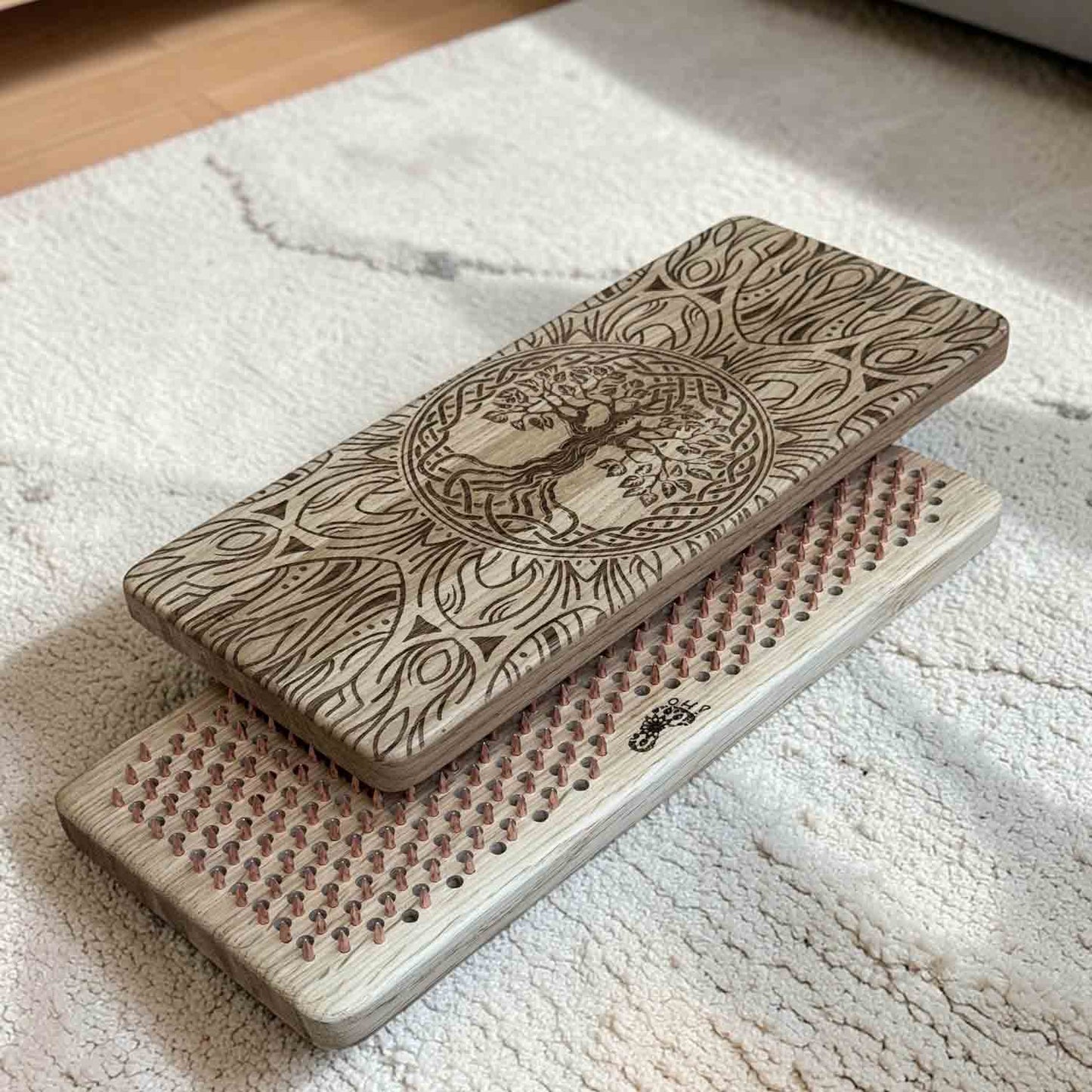 Sadhu board copper nails with laser engraving on a carpet in room