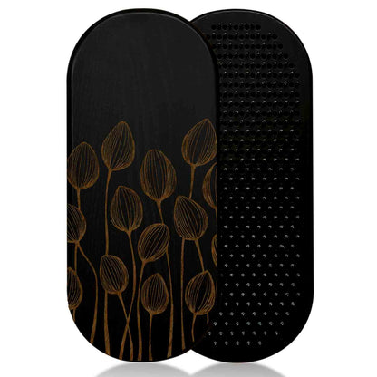 Black ash wood sadhu board with floral design on one and nails surface on the other, on a white background.