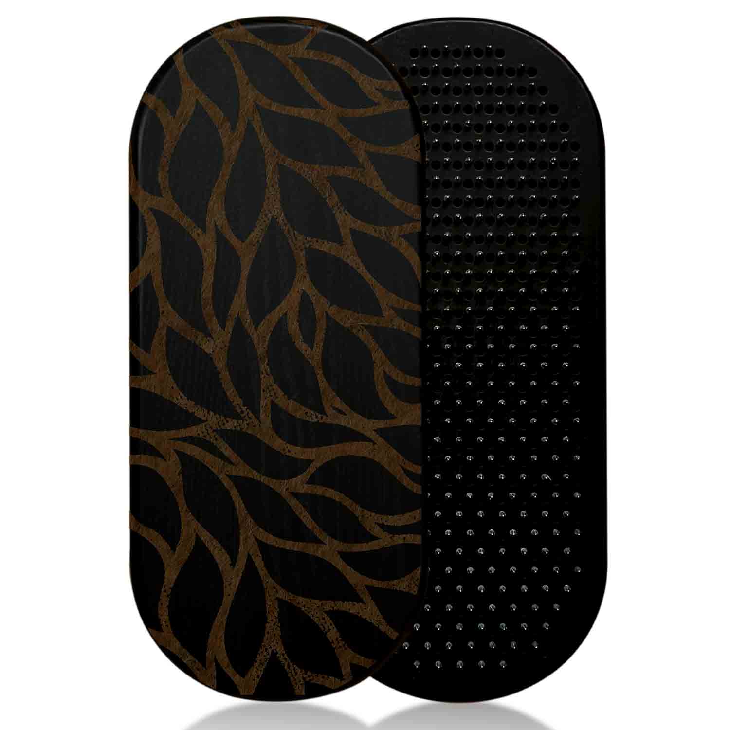 Two black sadhu boards with a leaf pattern and textured surface on a white background