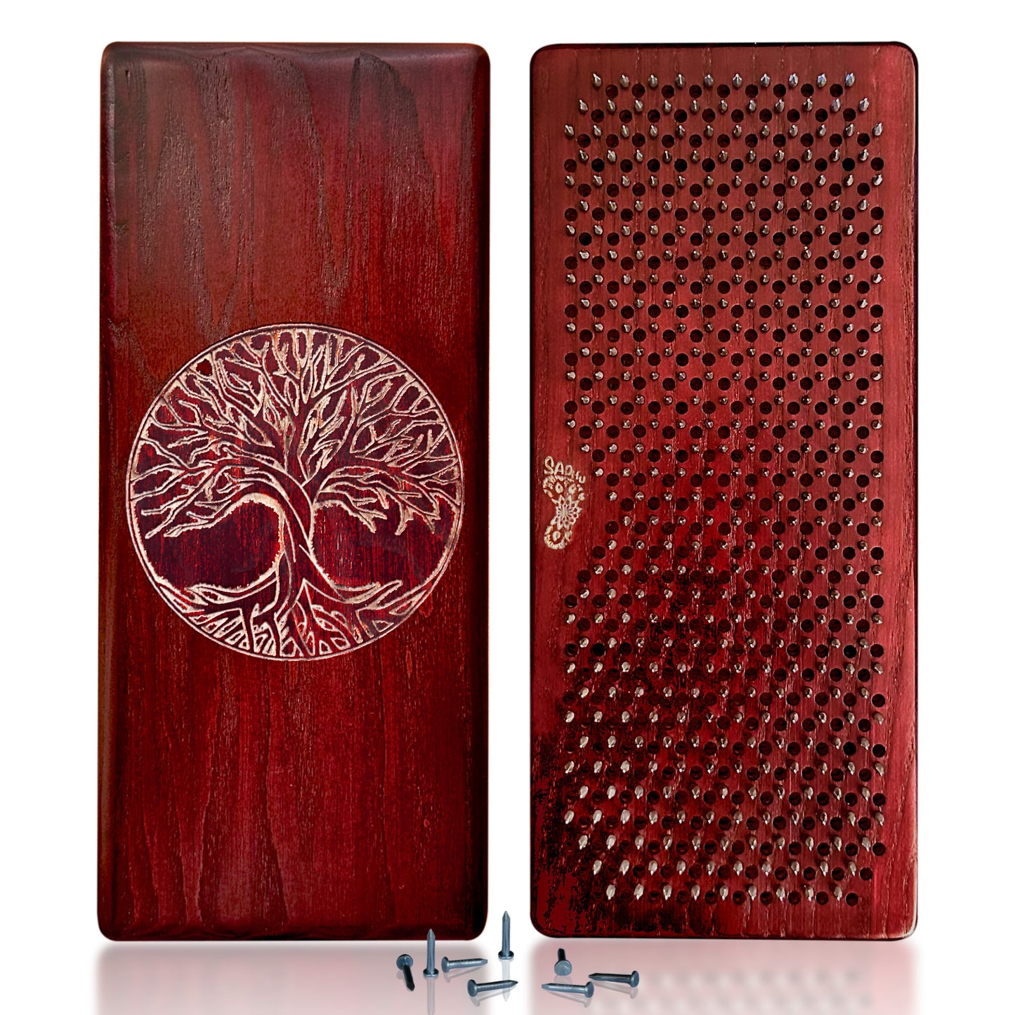 Two wooden Sadhu boards with a Tree of Life engraving on one side and a grid of evenly spaced nails on the other, shown side by side. Several loose nails are placed in front of the boards.