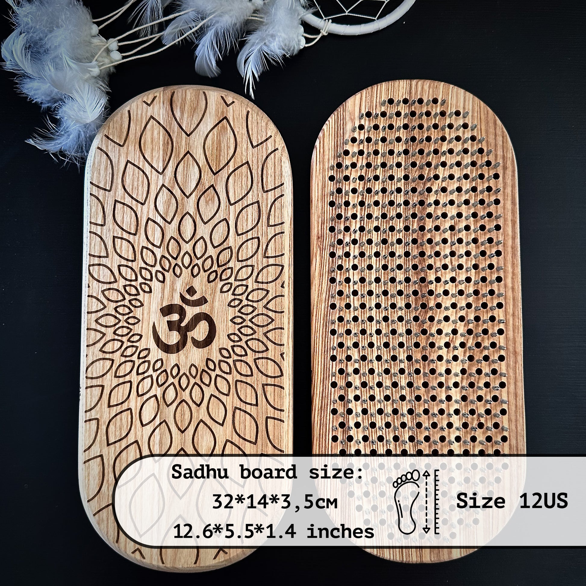 The image shows a pair of Sadhu boards, one with an Om symbol and a lotus design and the other with metal nails. The dimensions are 32 cm by 14 cm by 3.5 cm (12.6 inches by 5.5 inches by 1.4 inches), fitting a US size 12 foot. A feathered dreamcatcher is in the background.