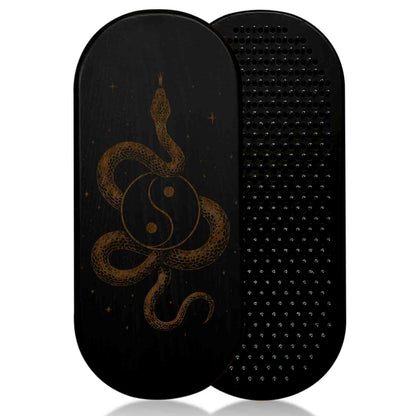 Black sadhu board with a snake and yin-yang design on a white background