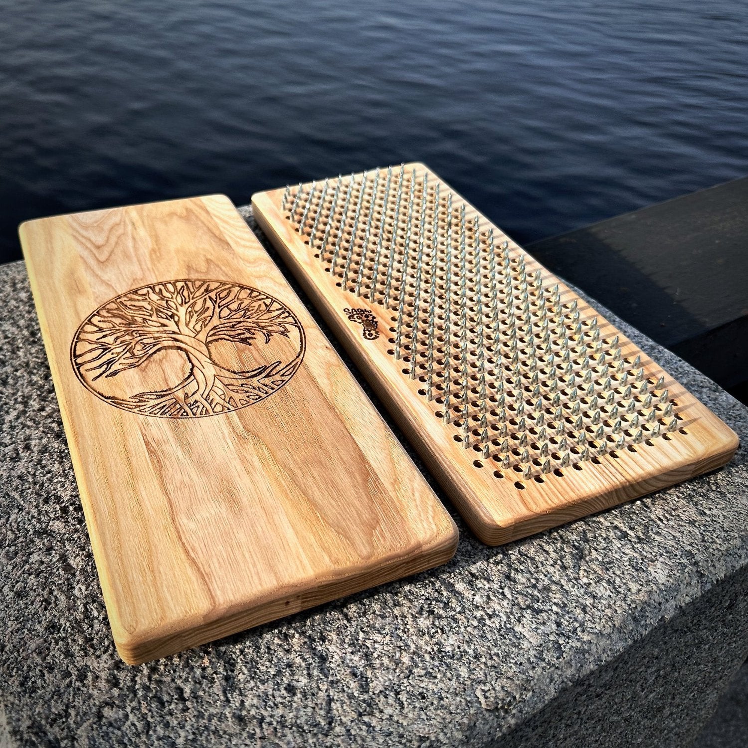 sadhu boards from ash wood wth nails in raws on stone near river